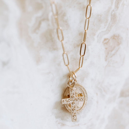 lose-up of 14k gold filled Virgin Mary medallion and textured cross charm