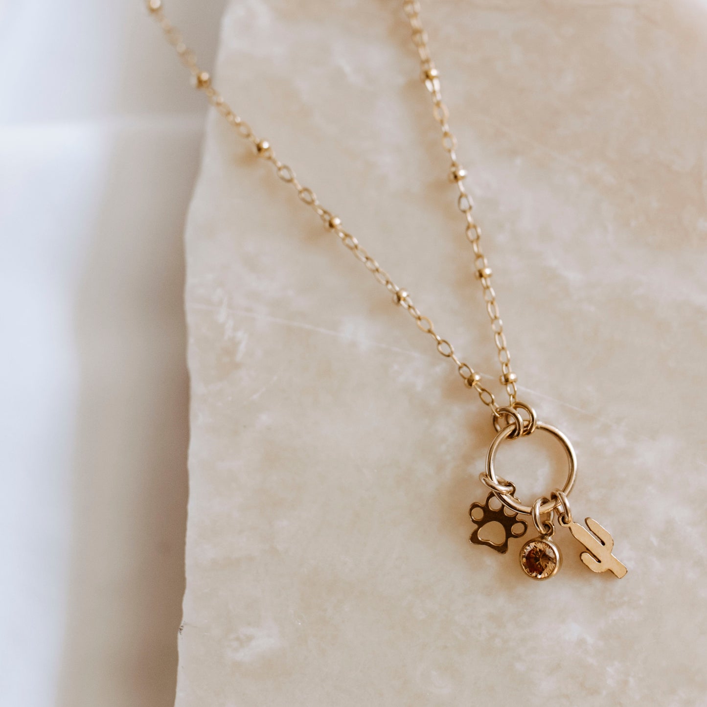14K gold filled custom charm necklace with multiple dainty charms on delicate chain