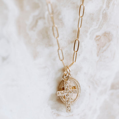 lose-up of 14k gold filled Virgin Mary medallion and textured cross charm