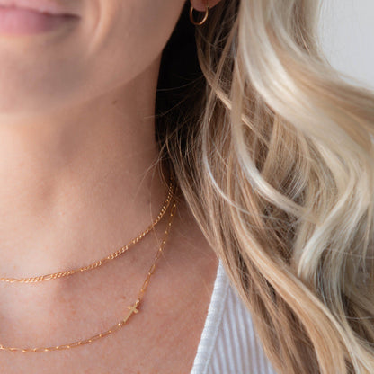 sideways gold cross necklace