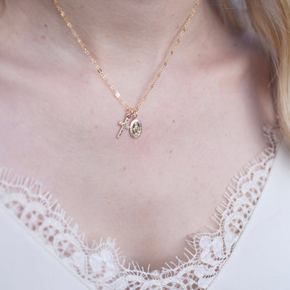 Gold filled Virgin Mary cross necklace worn on neckline, minimalist religious jewelry.